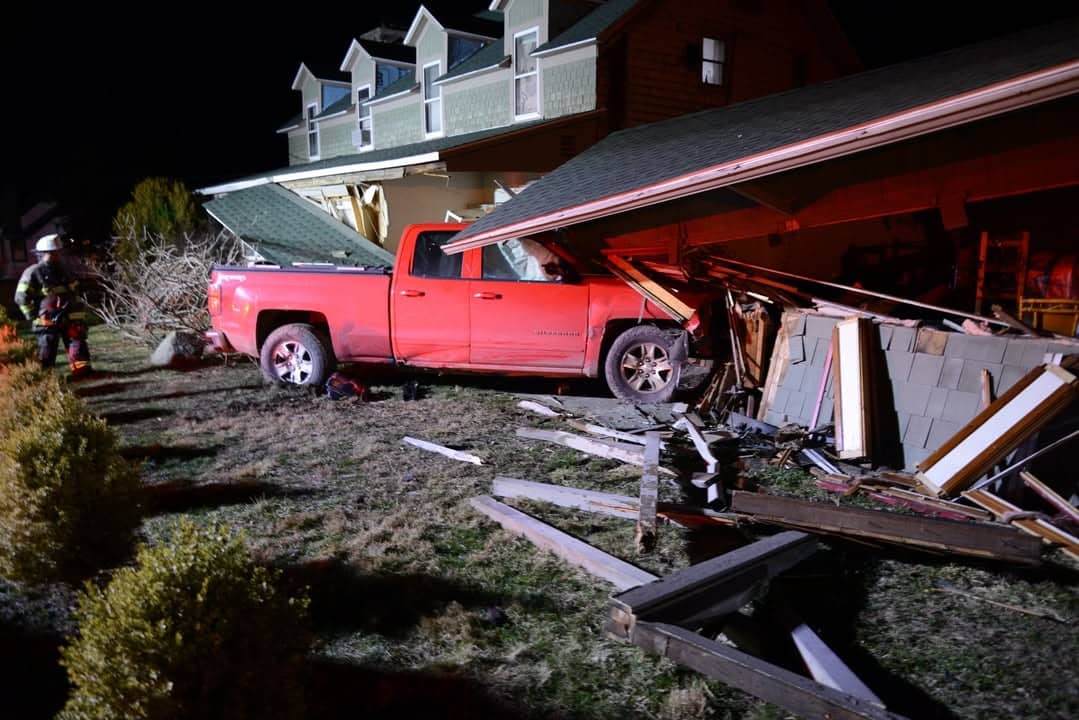 A red pick-up truck crashed into a garage